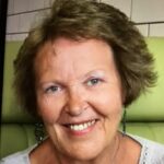 Jackie Sully DL A head shot of a smiling woman with bobbed dark blond hair.